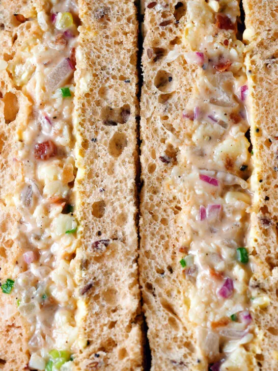 Close-up cheese and onion sandwich with Branston pickle on malted bread.