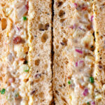 Close-up cheese and onion sandwich with Branston pickle on malted bread.