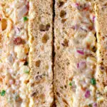 Close-up cheese and onion sandwich with Branston pickle on malted bread.