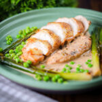 Chicken breast with a creamy cider and mustard sauce served with peas and baby leeks.