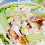 Close-up chicken Waldorf salad wraps in a flour tortilla.