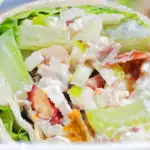 Close-up chicken Waldorf salad wraps in a flour tortilla.