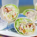 Chicken Waldorf salad wraps in flour tortillas served at a picnic.