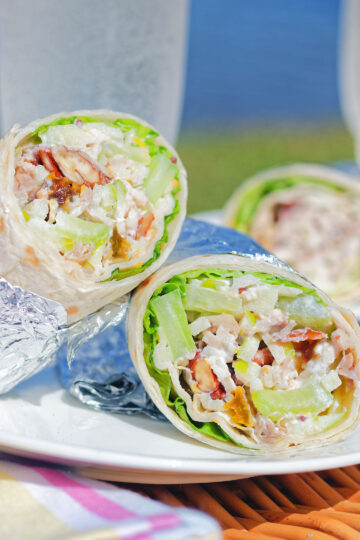 Chicken Waldorf salad wraps in flour tortillas served at a picnic.