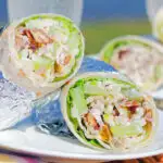 Chicken Waldorf salad wraps in flour tortillas served at a picnic.