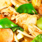 Close-up homemade Chinese chicken chop suey fakeaway served with egg fried rice.