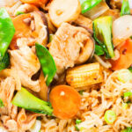 Overhead close-up homemade Chinese chicken chop suey fakeaway served with egg fried rice.