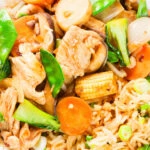 Overhead close-up homemade Chinese chicken chop suey fakeaway served with egg fried rice.