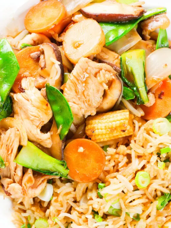 Overhead close-up homemade Chinese chicken chop suey fakeaway served with egg fried rice.