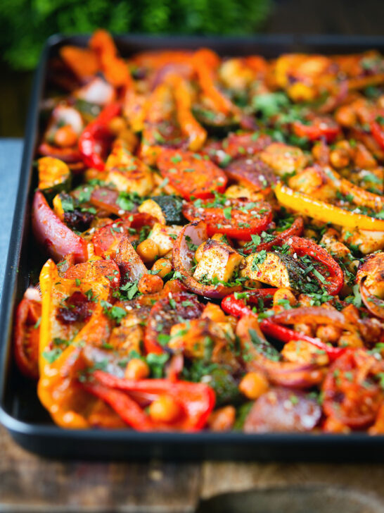 Halloumi tray bake with Mediterranean vegetables, chickpeas and spicy harissa.