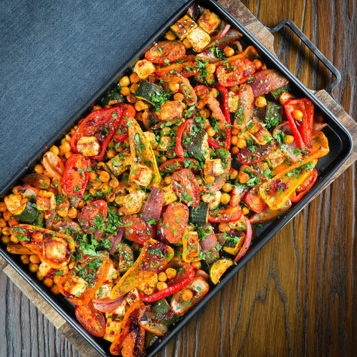 Halloumi tray bake with Mediterranean vegetables and chickpeas in a harissa and zaatar sauce.