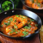 Indian takeaway inspired king prawn Balti curry with naan bread.
