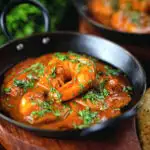 Indian takeaway inspired king prawn Balti curry with naan bread.