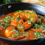 Close-up Indian takeaway inspired king prawn Balti curry.