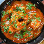 Overhead close-up Indian takeaway inspired king prawn Balti curry.