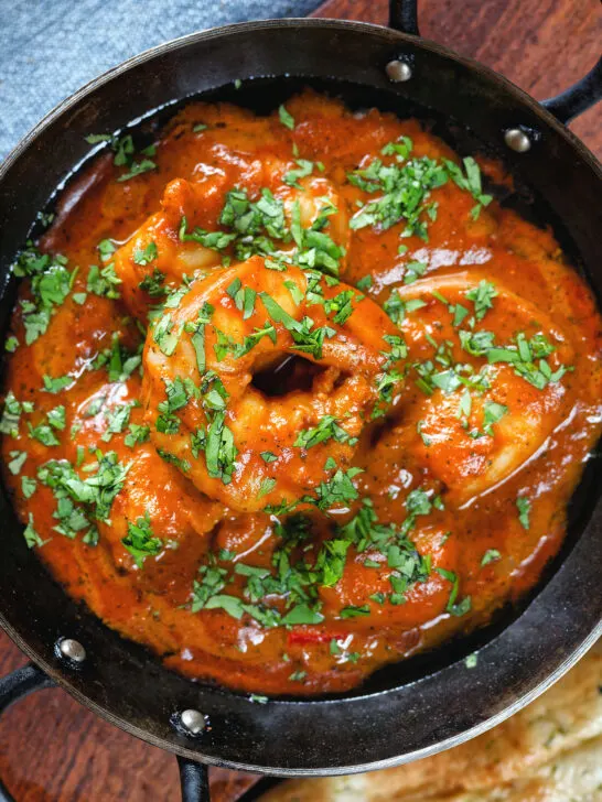 Overhead close-up Indian takeaway inspired king prawn Balti curry.