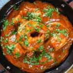 Overhead close-up Indian takeaway inspired king prawn Balti curry.