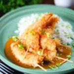 Crispy king prawn katsu curry served with spring onion rice.