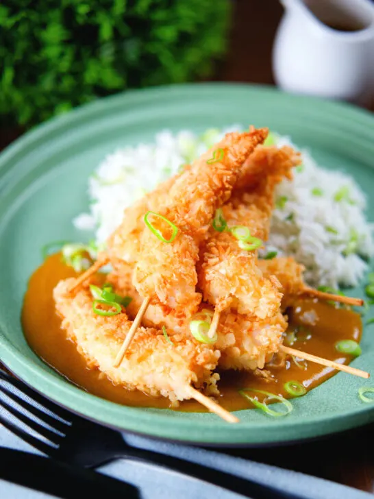 Crispy king prawn katsu curry served with spring onion rice.