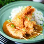 Crispy king prawn katsu curry served with spring onion rice.