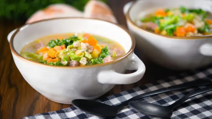 Homemade traditional Scotch broth soup with lamb, barley and savoy cabbage.