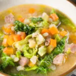 Close-up Scotch broth soup with lamb, pearl barley and savoy cabbage.