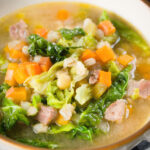 Close-up Scotch broth soup with lamb, pearl barley and savoy cabbage.