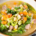 Close-up Scotch broth soup with lamb, pearl barley and savoy cabbage.