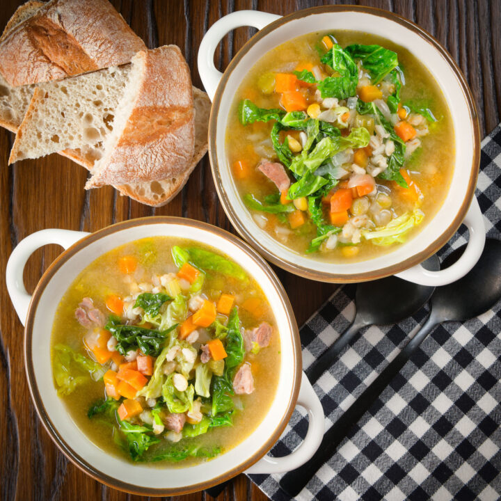 Homemade traditional Scotch broth soup with lamb, barley and savoy cabbage.