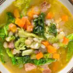 Overhead close-up Scotch broth soup with lamb, pearl barley and savoy cabbage.