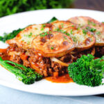 Minced beef and onion hotpot with a scalloped potato lid served with broccoli and fine beans.