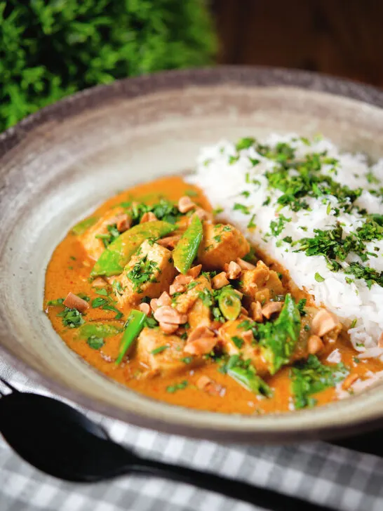Satay chicken curry with peanuts and coriander served with steamed rice.