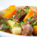 Close-up slow cooker Irish stew with lamb, potatoes and carrots.