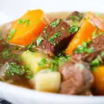 Close-up slow cooker Irish stew with lamb, potatoes and carrots.