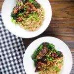 Overhead spicy fried tofu with black bean sauce and tenderstem broccoli served with egg fried rice.