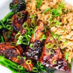 Close-up overhead spicy fried tofu with black bean sauce and tenderstem broccoli served with egg fried rice.