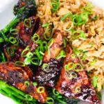Close-up overhead spicy fried tofu with black bean sauce and tenderstem broccoli served with egg fried rice.