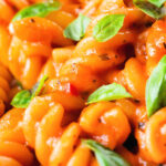 Close-up tomato, basil and and mascarpone cheese pasta.