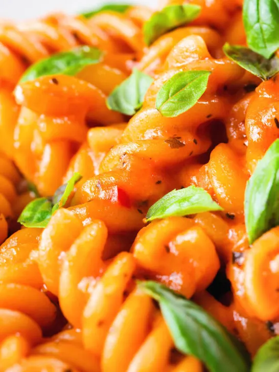 Close-up tomato, basil and and mascarpone cheese pasta.