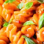 Close-up tomato, basil and and mascarpone cheese pasta.