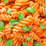 Close-up overhead tomato, basil and and mascarpone cheese pasta.