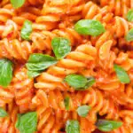 Close-up overhead tomato, basil and and mascarpone cheese pasta.