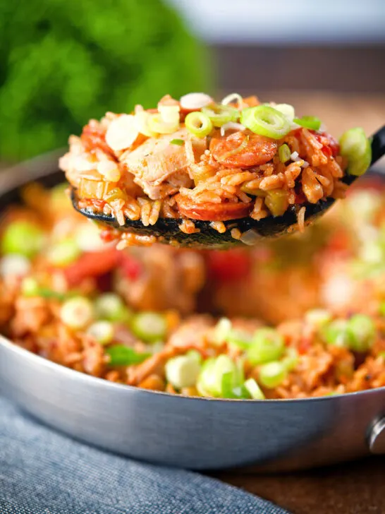 One-pot Cajun-influenced chicken and chorizo jambalaya on a spoon.