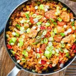 Overhead one-pot Cajun-influenced chicken and chorizo jambalaya.