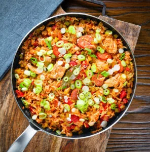 One-pot Cajun chicken and chorizo jambalaya with spring onions.