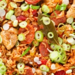 Overhead close-up one-pot Cajun-influenced chicken and chorizo jambalaya.