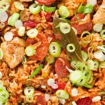 Overhead close-up one-pot Cajun-influenced chicken and chorizo jambalaya.