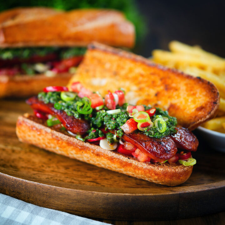 Choripan sandwich with Spanish chorizo, chimichurri and salsa served with French fries.