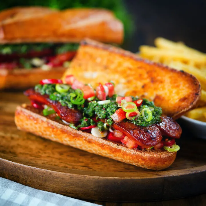 Choripan sandwich with Spanish chorizo, chimichurri and salsa served with French fries.