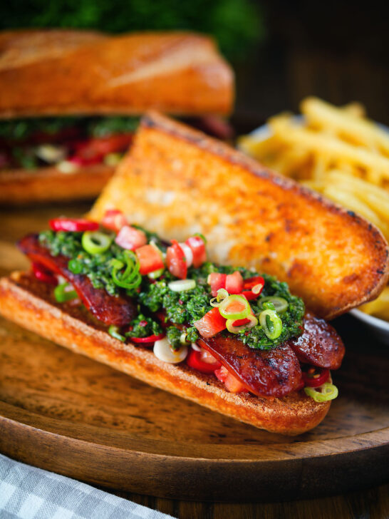 Argentinian-Influenced choripan sandwich with Spanish chorizo, chimichurri and salsa
